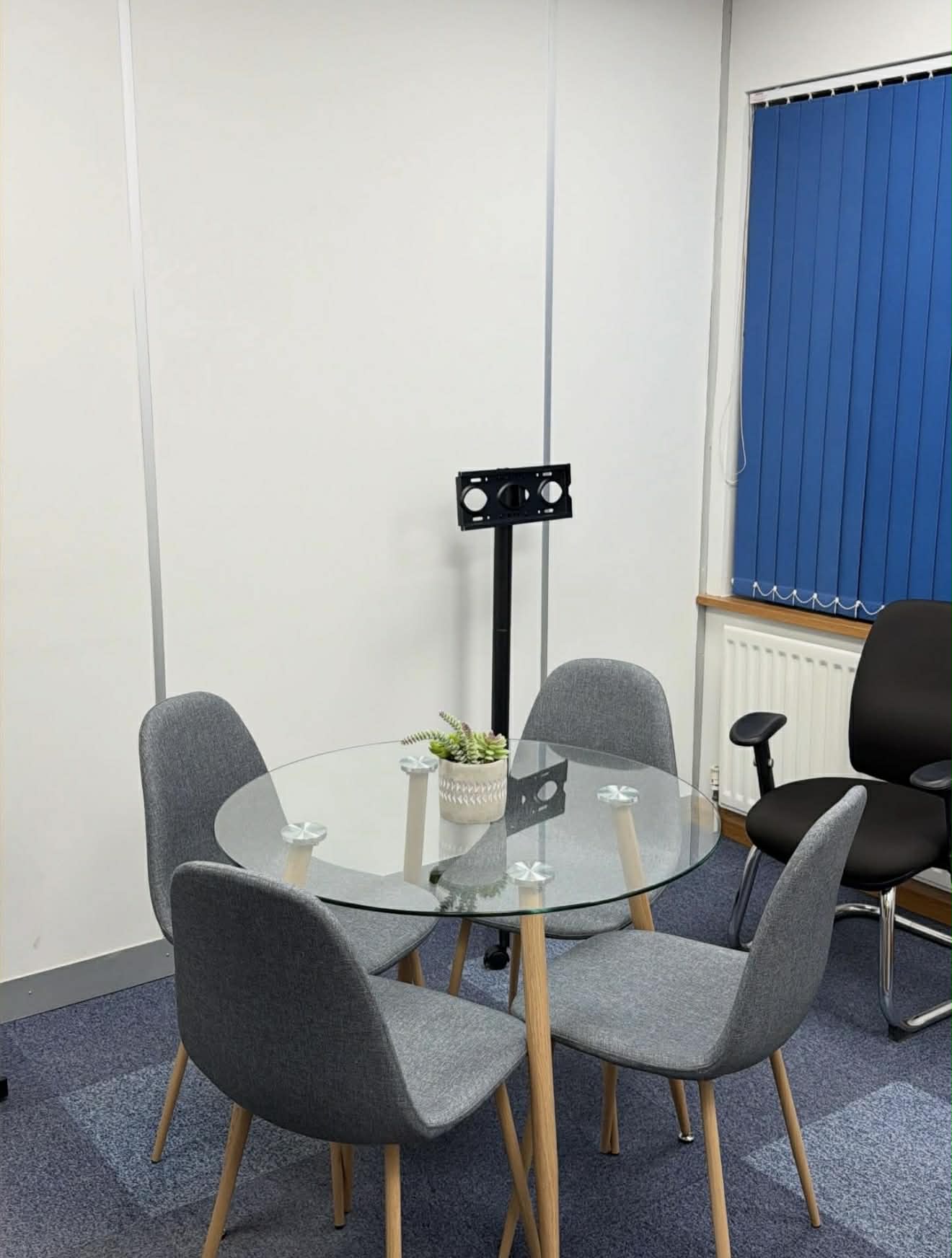 Clean meeting room with polished glass table
